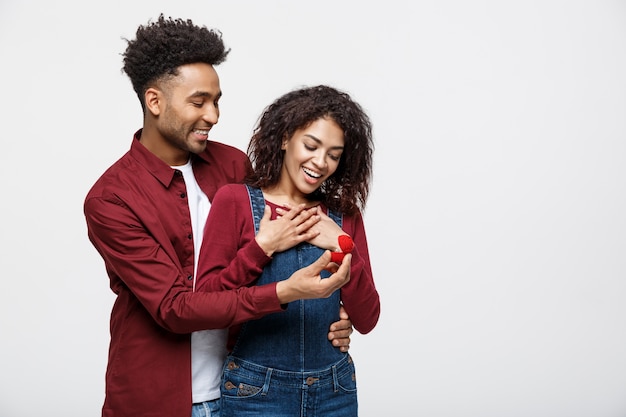 若いハンサムなアフリカ系アメリカ人男性は意外にもプロポーズのために彼女のガールフレンドに尋ねます。