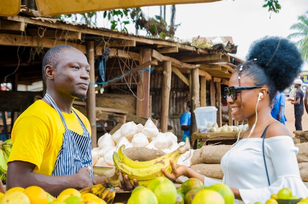 A young handsome african man feeling excited as he sells to his beautiful customer