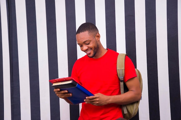 Young handsome african man studying his book