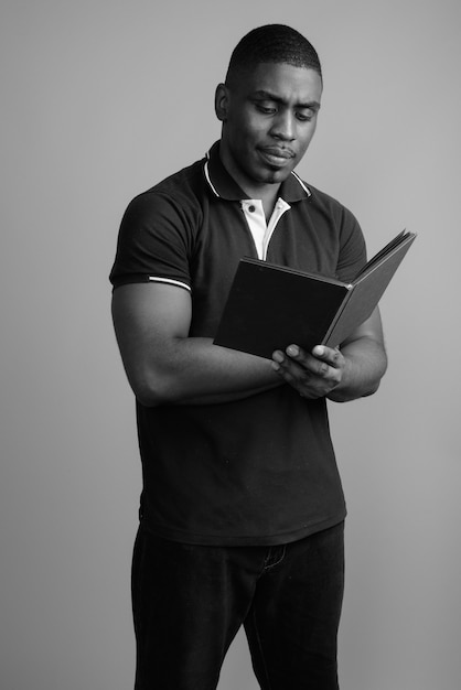 young handsome African man wearing polo shirt. black and white