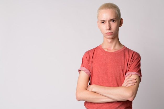  young handsome androgynous man against white wall