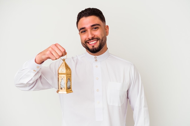 Young handsome arab man holding a lamp