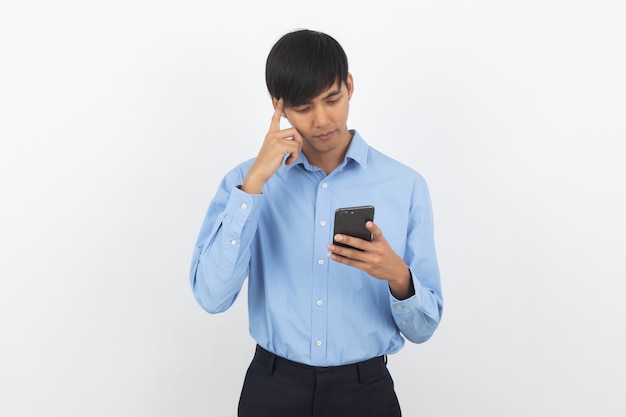 Young handsome asian business man holding a black smartphone and thinking an idea