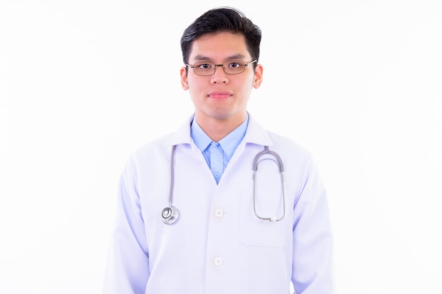  young handsome Asian man doctor with eyeglasses isolated against white wall