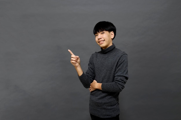 Young handsome Asian man posing at studio