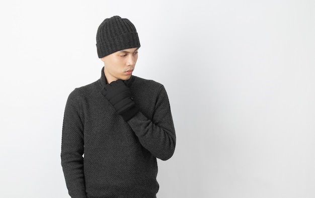 Young handsome asian man wearing grey sweater and beanie thinking an idea while looking up