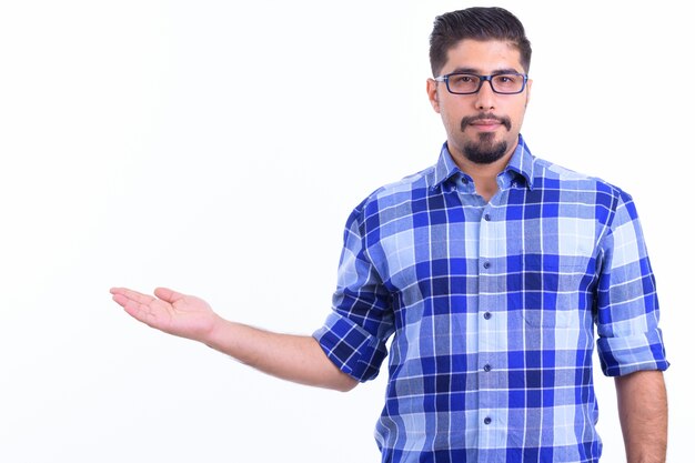 young handsome bearded Iranian hipster man with eyeglasses isolated on white