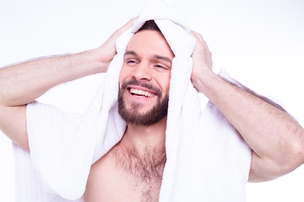 Young handsome bearded man after bath with white towel Isolated photo of young naked guy