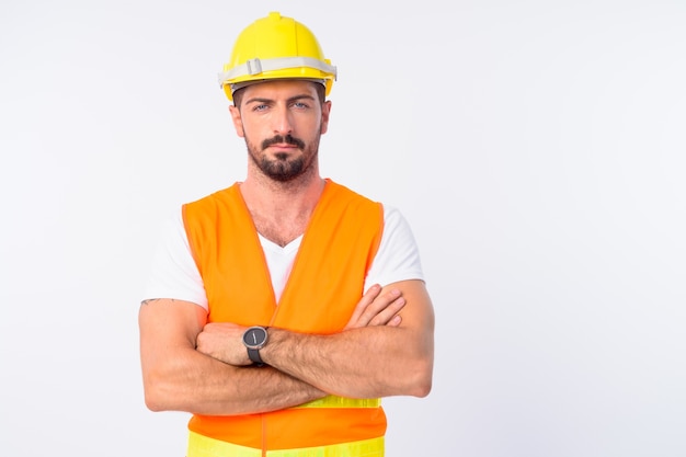  young handsome bearded man construction worker isolated against white wall