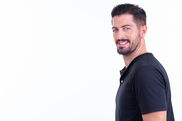 young handsome bearded man isolated against white wall