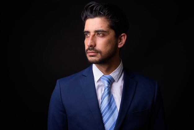 young handsome bearded Persian businessman on black