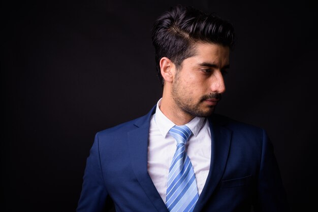 young handsome bearded Persian businessman on black