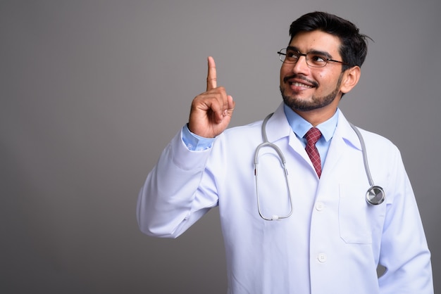 young handsome bearded Persian man doctor wearing eyeglasses 