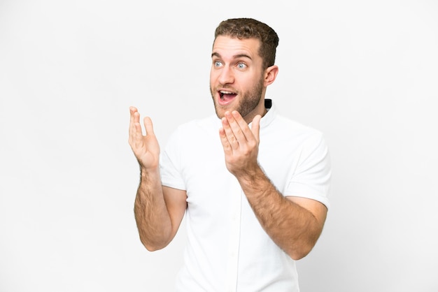 Young handsome blonde man over isolated white background with surprise facial expression