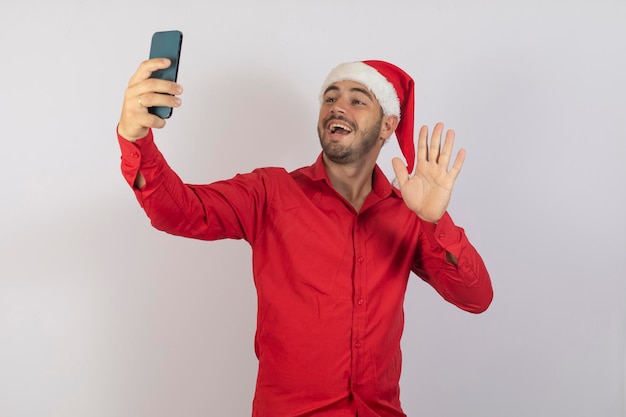 Young handsome boy dressed for christmas on video call or taking a selfie