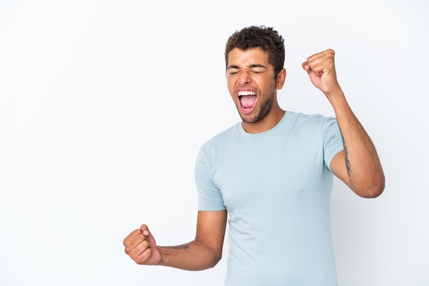 Young handsome Brazilian man isolated on white background celebrating a victory