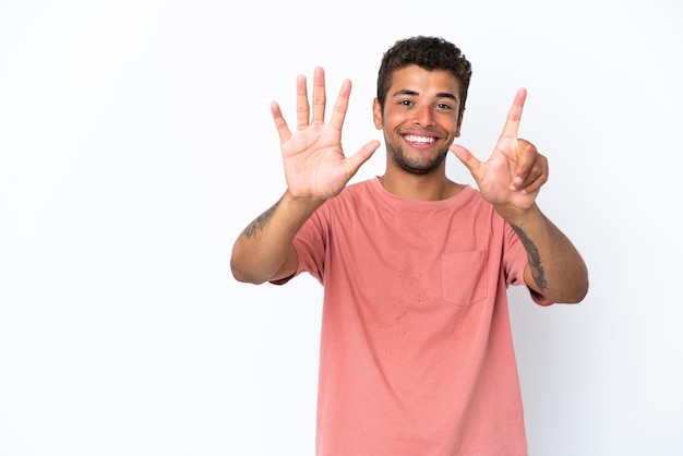 Young handsome Brazilian man isolated on white background counting seven with fingers