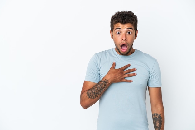 Young handsome Brazilian man isolated on white background surprised and shocked while looking right