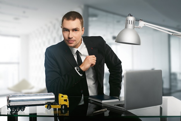 Young handsome business man on a desk 