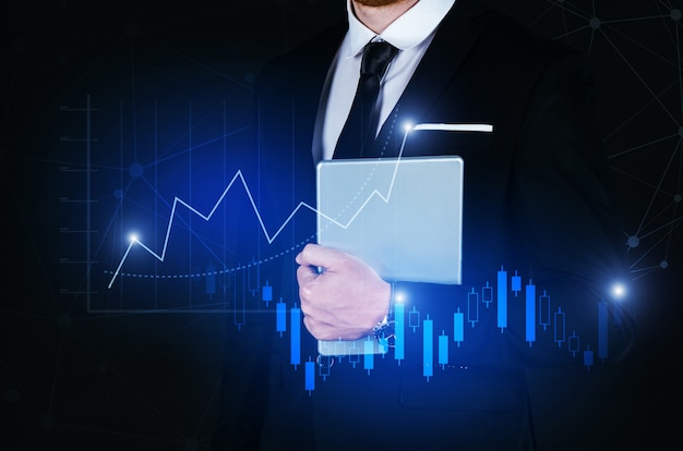 Photo young handsome business man holding mobile smart tablet with effect global network link connection and graph chart of stock market graphic diagram