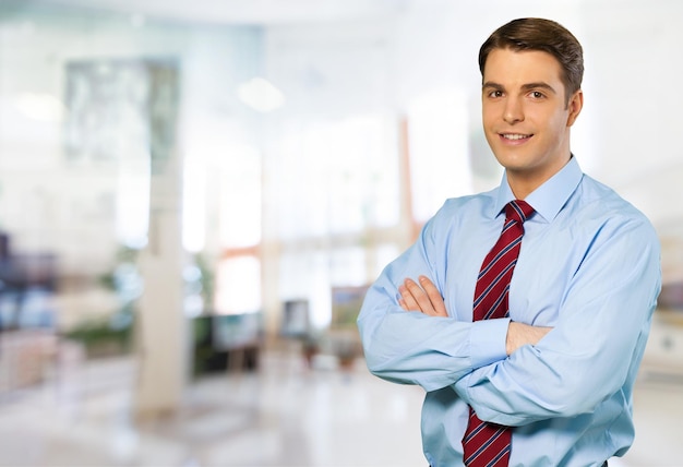 Young handsome businessman on background