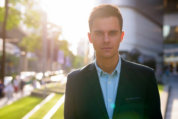 Young handsome businessman exploring the city