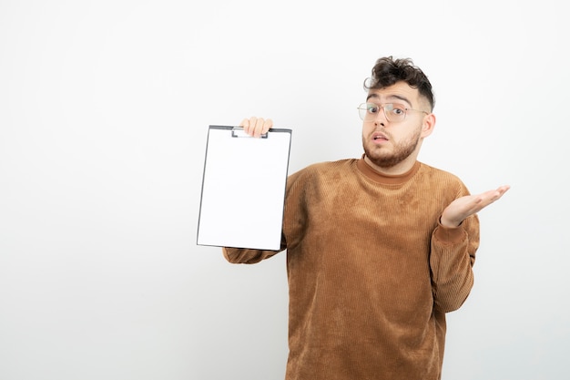 young handsome businessman in glasses with notes standing. 