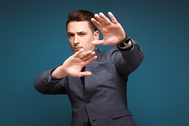 Young handsome businessman in grey jacket and black shirt