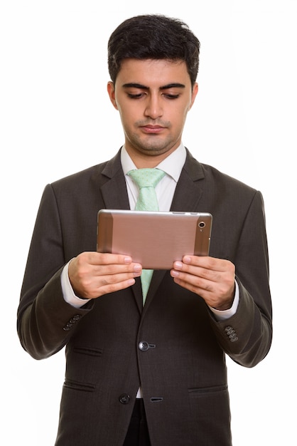 Young handsome businessman holding digital tablet