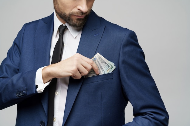 Young handsome businessman holding US dollar bills