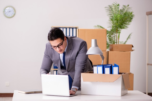 Young handsome businessman moving offices