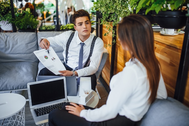 Young handsome businessman shows an employee schedule