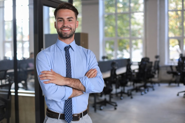 Young handsome businessman smiling in an office environment