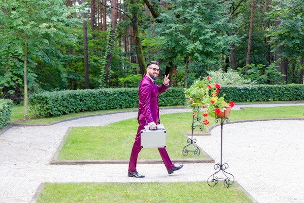 A young handsome businessman walking on the Park