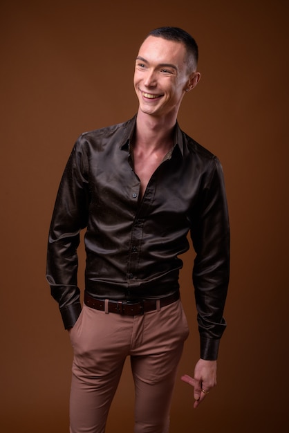 Young handsome businessman wearing black satin shirt