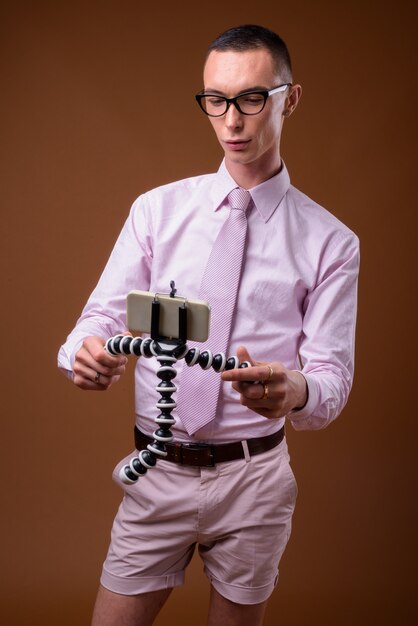 Young handsome businessman wearing pink shirt