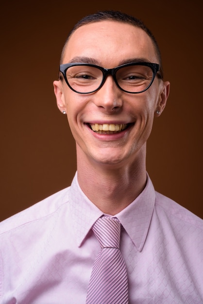 Young handsome businessman wearing pink shirt