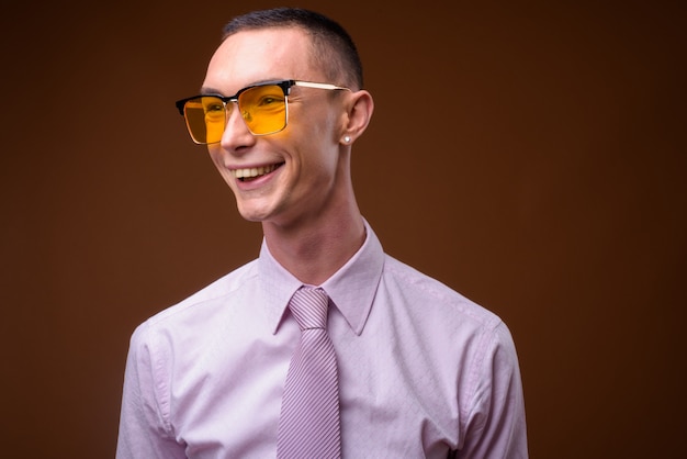 Young handsome businessman wearing pink shirt