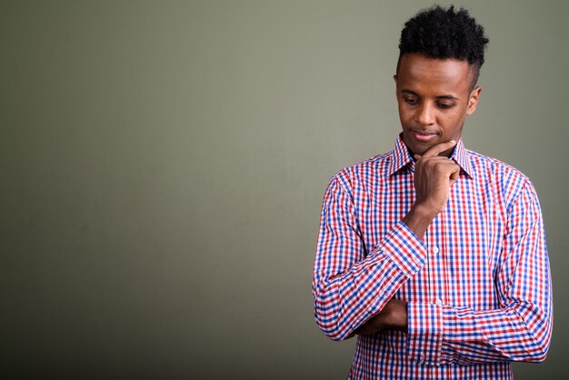 Young handsome businessman wearing purple checkered shirt