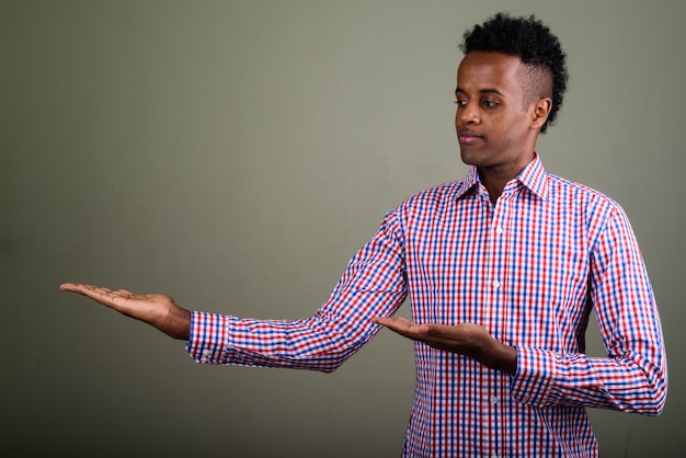 Young handsome businessman wearing purple checkered shirt