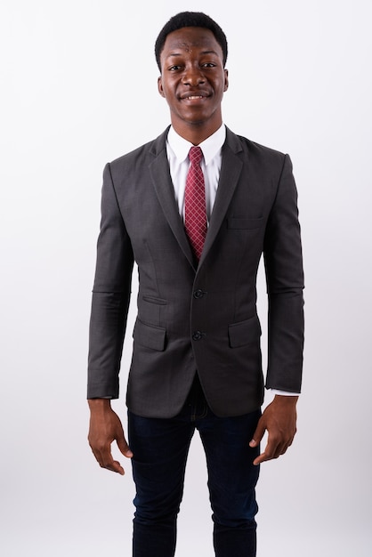 Young handsome businessman wearing suit against white