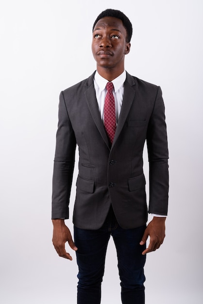 Young handsome businessman wearing suit against white