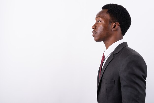 Young handsome businessman wearing suit against white