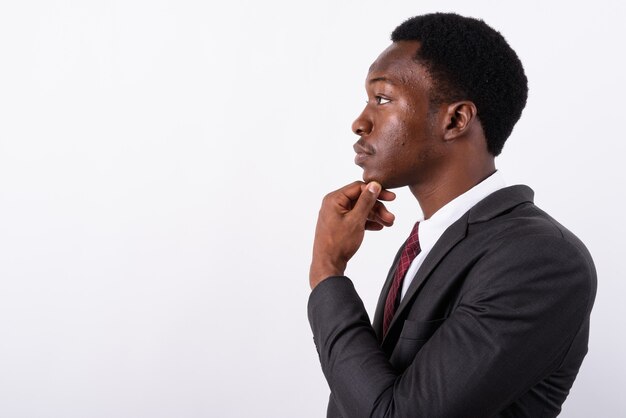 Young handsome businessman wearing suit against white