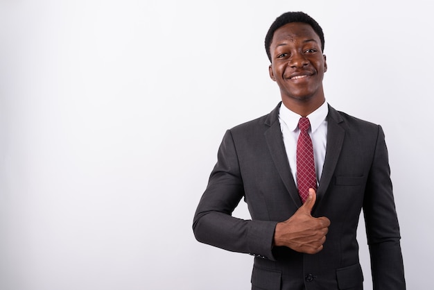 Young handsome businessman wearing suit against white