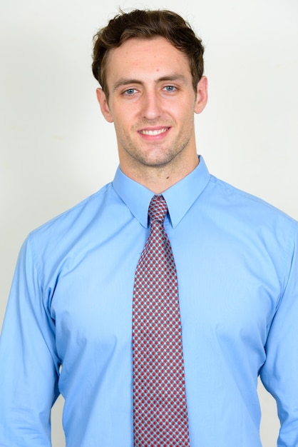 Young handsome businessman with wavy hair isolated