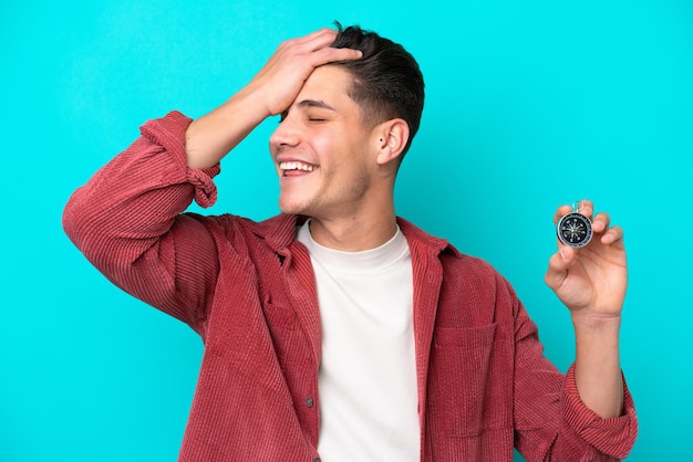 Young handsome caucasian man holding compass has realized something and intending the solution