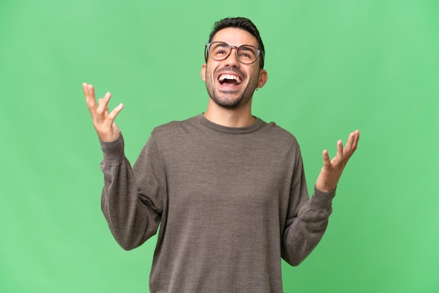 Young handsome caucasian man over isolated background smiling a lot