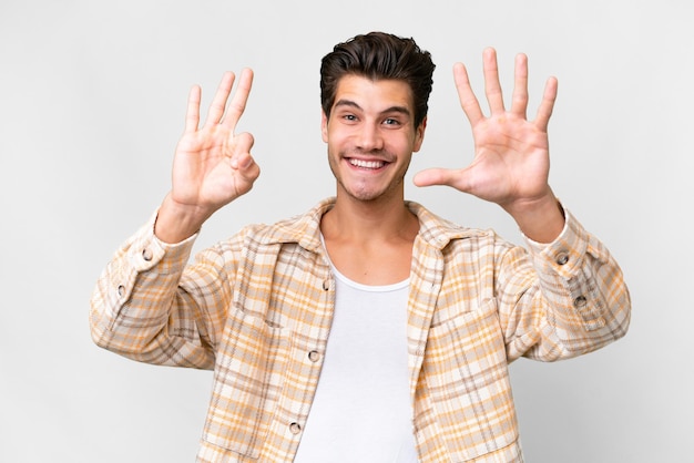 Young handsome caucasian man over isolated white background counting eight with fingers