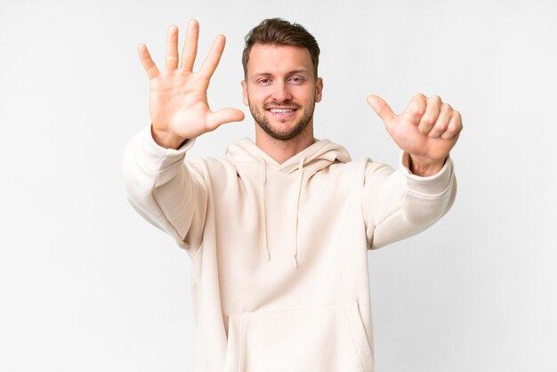 Young handsome caucasian man over isolated white background counting six with fingers